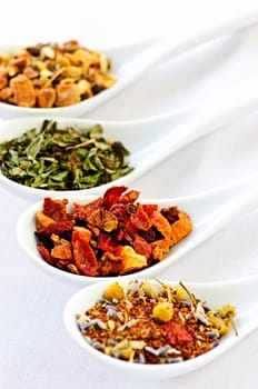 Assorted herbal wellness dry tea in spoons