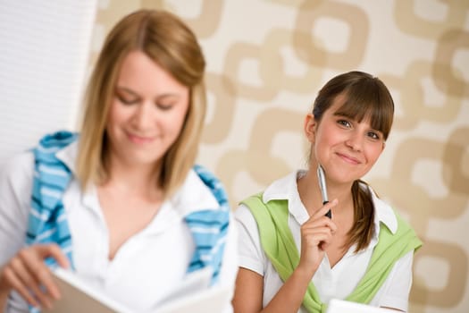 Student at home - two woman with book