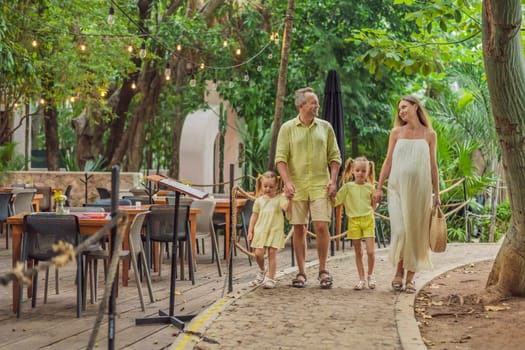 A joyful family, two girls, dad, and a pregnant mom, bask in tropical resort, celebrating a radiant pregnancy amidst paradise.