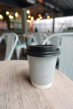 Blank take away kraft coffee cup on table