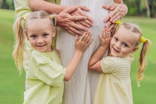 Sisters' love blooms as they tenderly embrace their mother's pregnant belly, sharing anticipation and affection for their soon-to-arrive sibling.