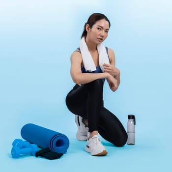 Athletic and sporty asian woman resting after intensive cardio workout training. Healthy exercising and fit body care lifestyle pursuit in studio shot isolated background. Vigorous