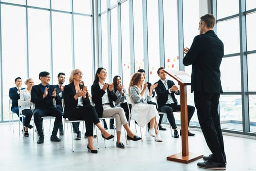 Group of business people meeting in a seminar conference . Audience listening to instructor in employee education training session . Office worker community summit forum with expert speaker . Jivy