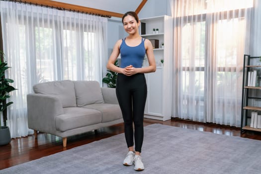 Full body asian woman in sportswear portrait, smiling and posing cheerful gesture. Home workout training with attractive girl engage in her pursuit of healthy lifestyle. Vigorous