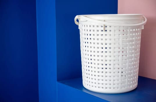 Empty new white plastic laundry clothes basket at convenience store for support customer, Laundromat convenience store, Laundry and housework concept