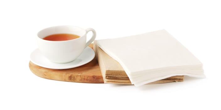 Cup of tea and paper napkin on white background close up
