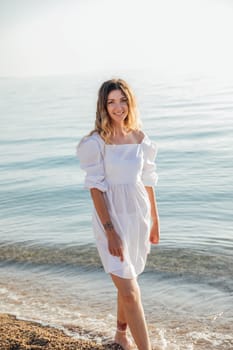 woman stands by the sea by the water on the beach rest walk