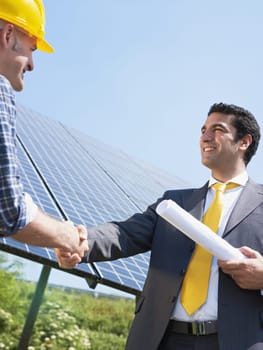 businessman and solar panels