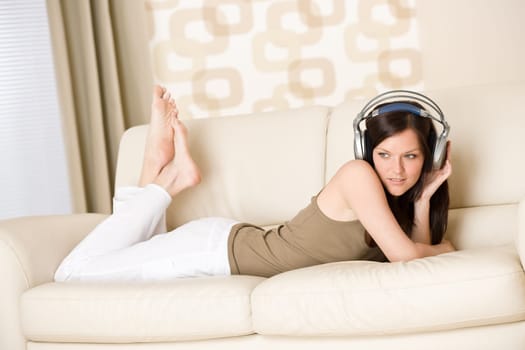 woman with headphones listen to music in lounge