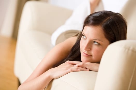 Young woman relax lying down on sofa