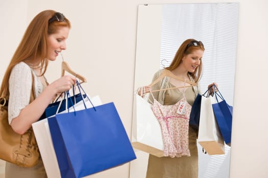 Fashion shopping - Happy woman try on sale clothes