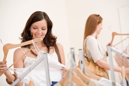 Fashion shopping - Two Happy woman choose sale clothes