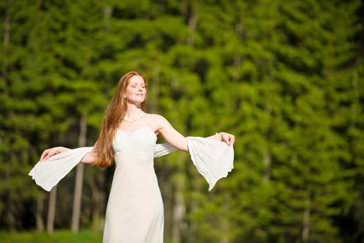 Long red hair romantic woman by lake