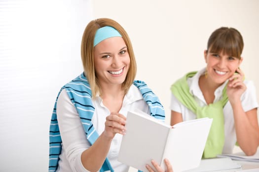 Student at home - two young woman study together