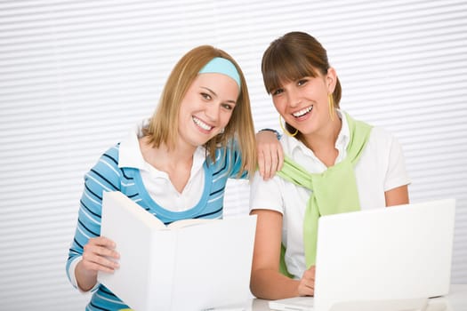 Student at home - two young woman study together