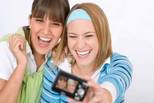 Two young cheerful woman taking picture