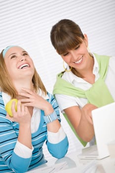 Student at home - two young woman study together