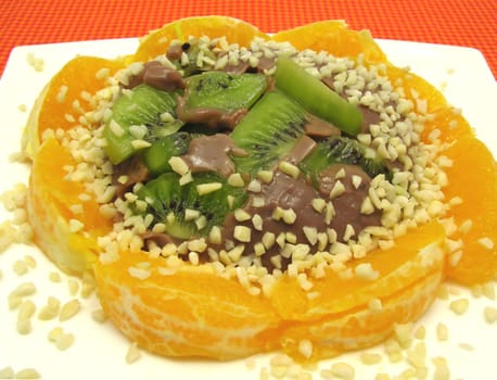 Chocolate pudding with kiwi,orange and almonds