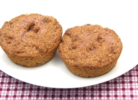 Two muffins on white porcelain plate