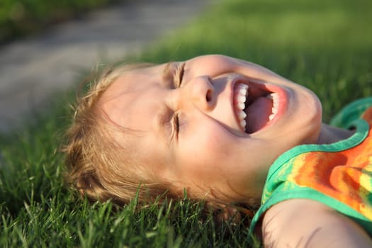 Happy girl relaxing on a grass