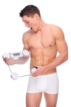 Young man with bathroom scales