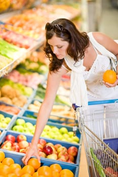 Grocery store - smiling woman shopping choose fruit