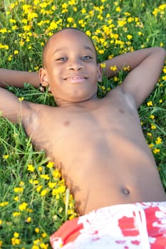 African boy lying on the grass