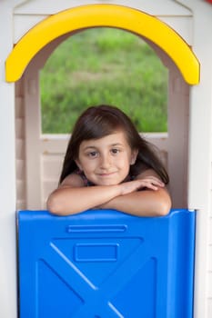 Playhouse with smiling little girl