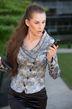 woman looking surprised on mobile phone
