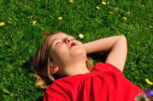 Child lying on meadow