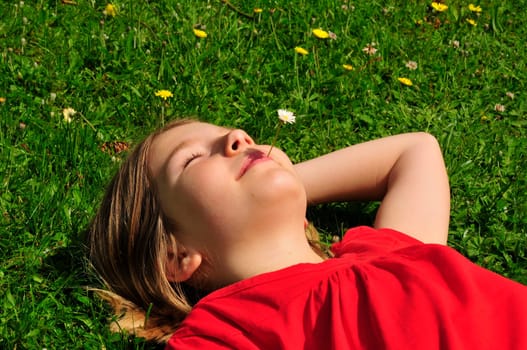 Child lying on meadow