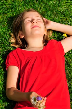 Child lying on meadow