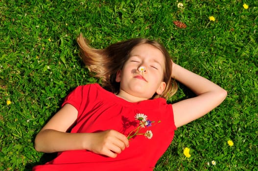 Child lying on meadow