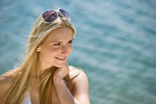 Blond woman in bikini with sunglasses
