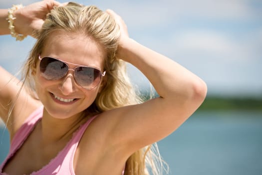 Blond woman with sunglasses enjoy sunny day