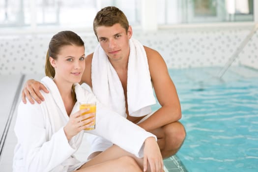 Luxury spa - young couple relax at pool
