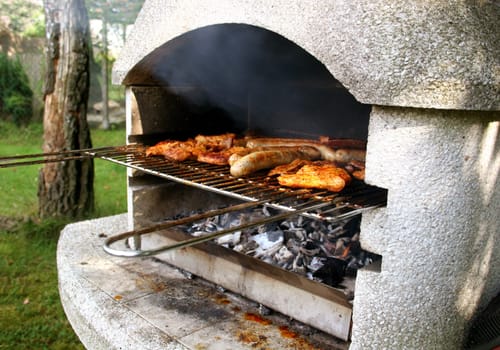 Garden grill with steaks and bratwurst