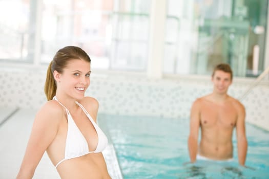 Swimming pool - young sportive couple relax
