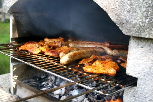 Garden grill with steaks and bratwurst