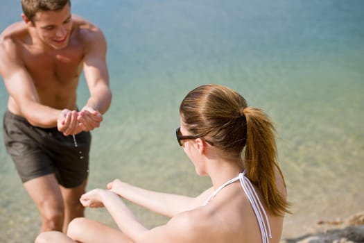 Young couple enjoy summer sun on beach