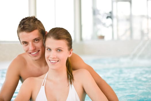 Swimming pool - young cheerful couple have fun