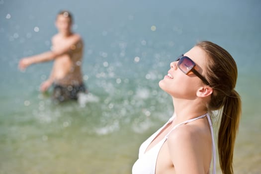 Young couple enjoy sun water on beach