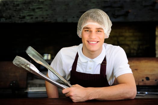 Man working in a restaurant with charcoal stove