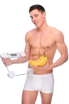 Young man with bathroom scales