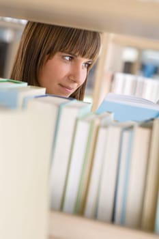 Student in library - happy woman study from book