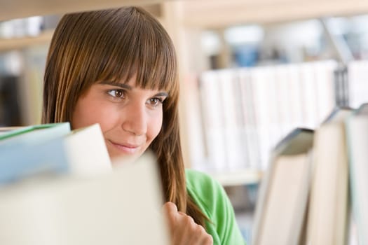 Student in library - happy woman search for book