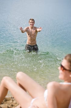 Couple enjoy sun and water on beach