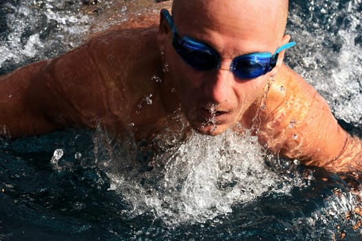 Detail of young man swimming