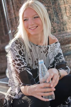 happy woman with bottle of water