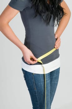 girl measuring her hip